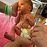 newborn, baby, hospital, medical_equipment, diaper, adult_hand, pink_blanket, monitor, tubes, wires, fragile, care, infant, medical_tape, bed, person, skin, healthcare, neonatal, premature
