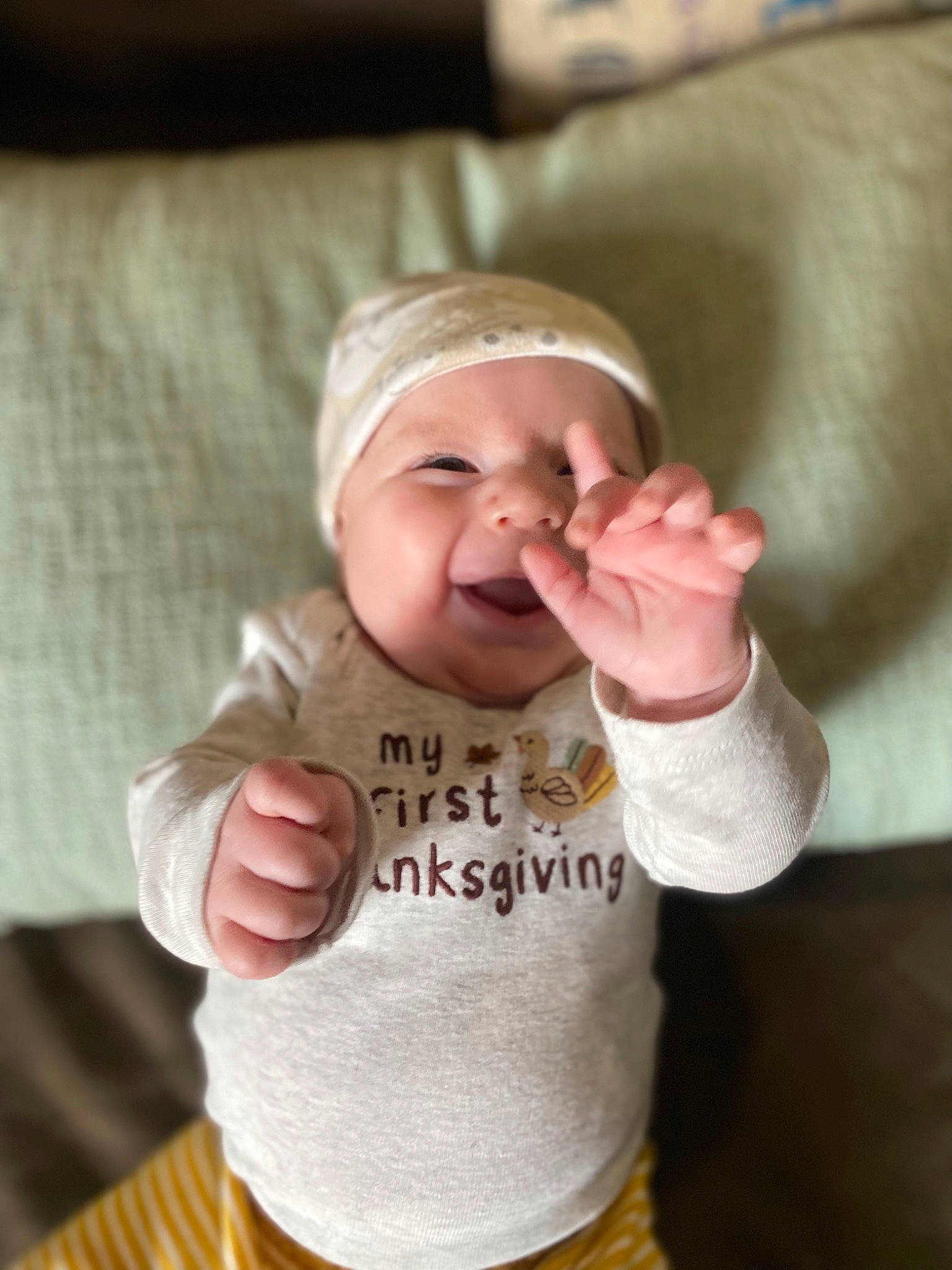 Chandler is registered to the contest to win money with this photo: baby, baby_toddler_clothing, cap, cheek, comfort, eye, face, finger, gesture, hand, happy, headgear, headwear, lip, nose, outerwear, person, skin, sleeve, smile