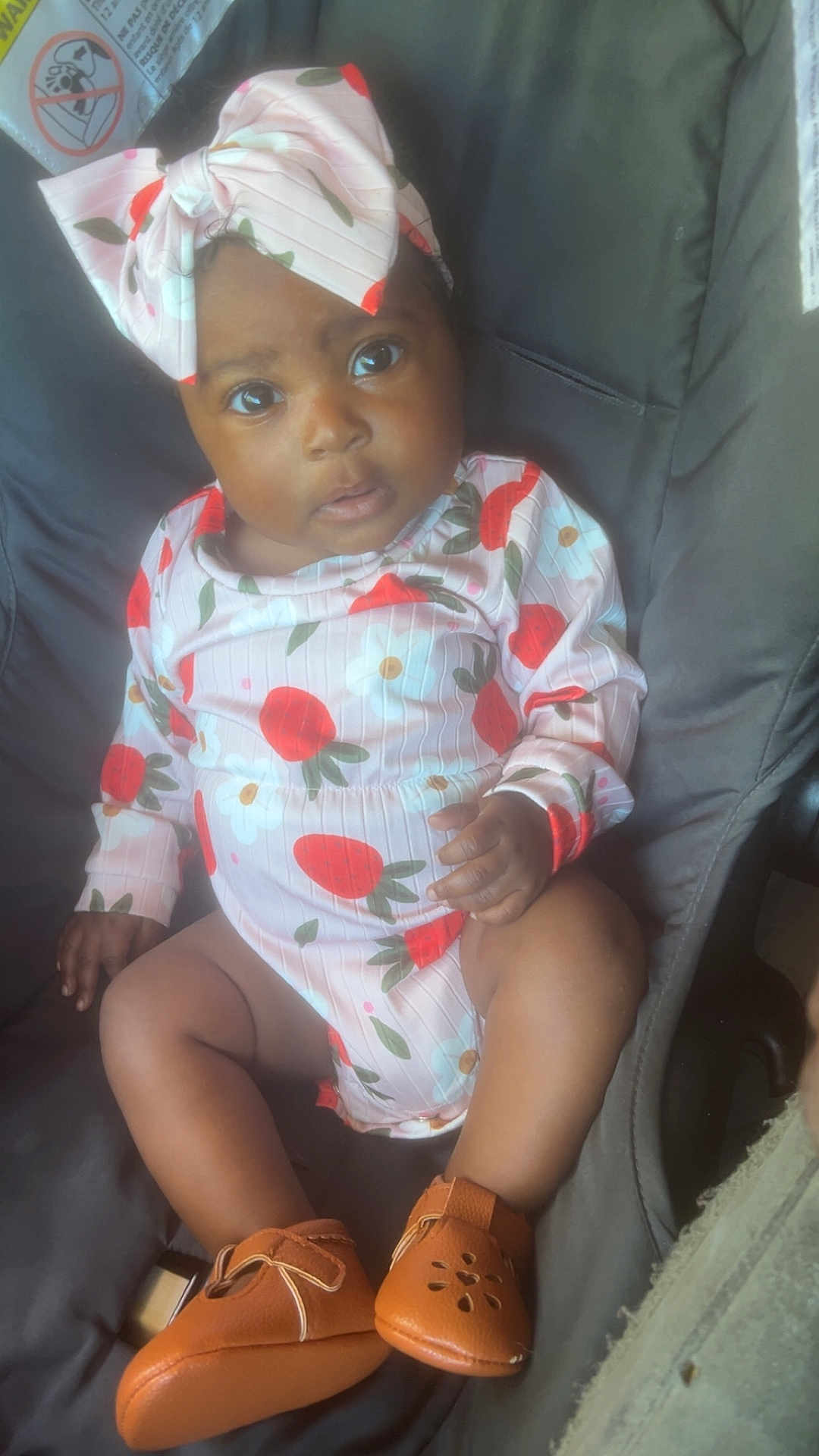 Aziyah joined the competition — help win amazing prizes! baby, child, infant, car_seat, onesie, bow, floral_pattern, shoes, leather_shoes, cute, looking_up, indoors, seatbelt_warning, hands, legs, portrait, young_child, sitting, clothing, footwear