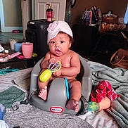 Wynter joined the competition — help win amazing prizes! baby, child, infant, toy, seat, little_tikes, hat, indoor, blanket, cup, furniture, clothing, floor, table, snack, bag, room, face, person, expression