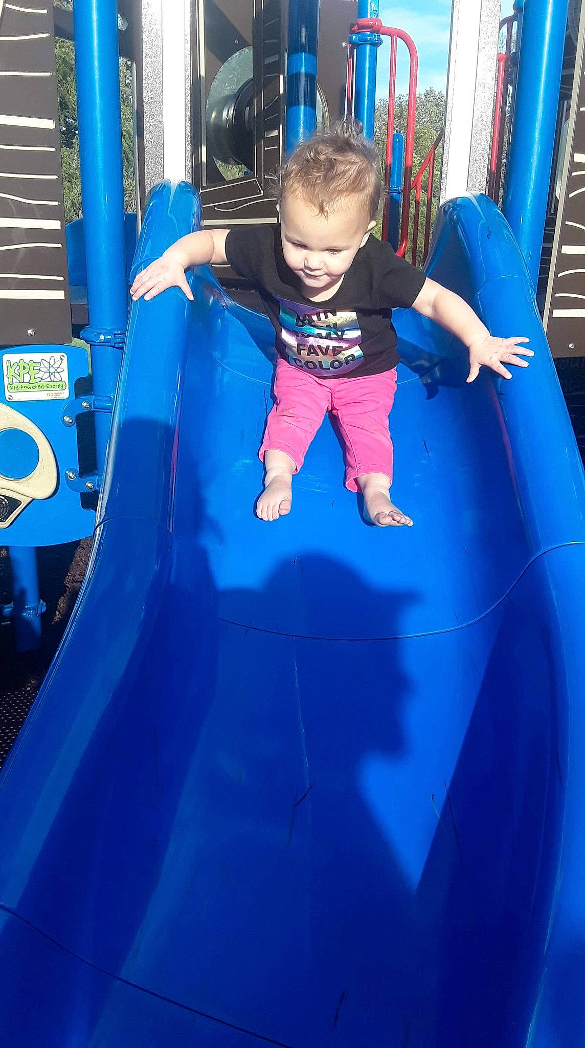 Lillyanna joined the competition — help win amazing prizes! blue, child, chute, city, electric_blue, fun, games, human_settlement, joy, leisure, outdoor_play_equipment, person, play, playground, playground_slide, public_space, recreation, smile, toddler, trampoline