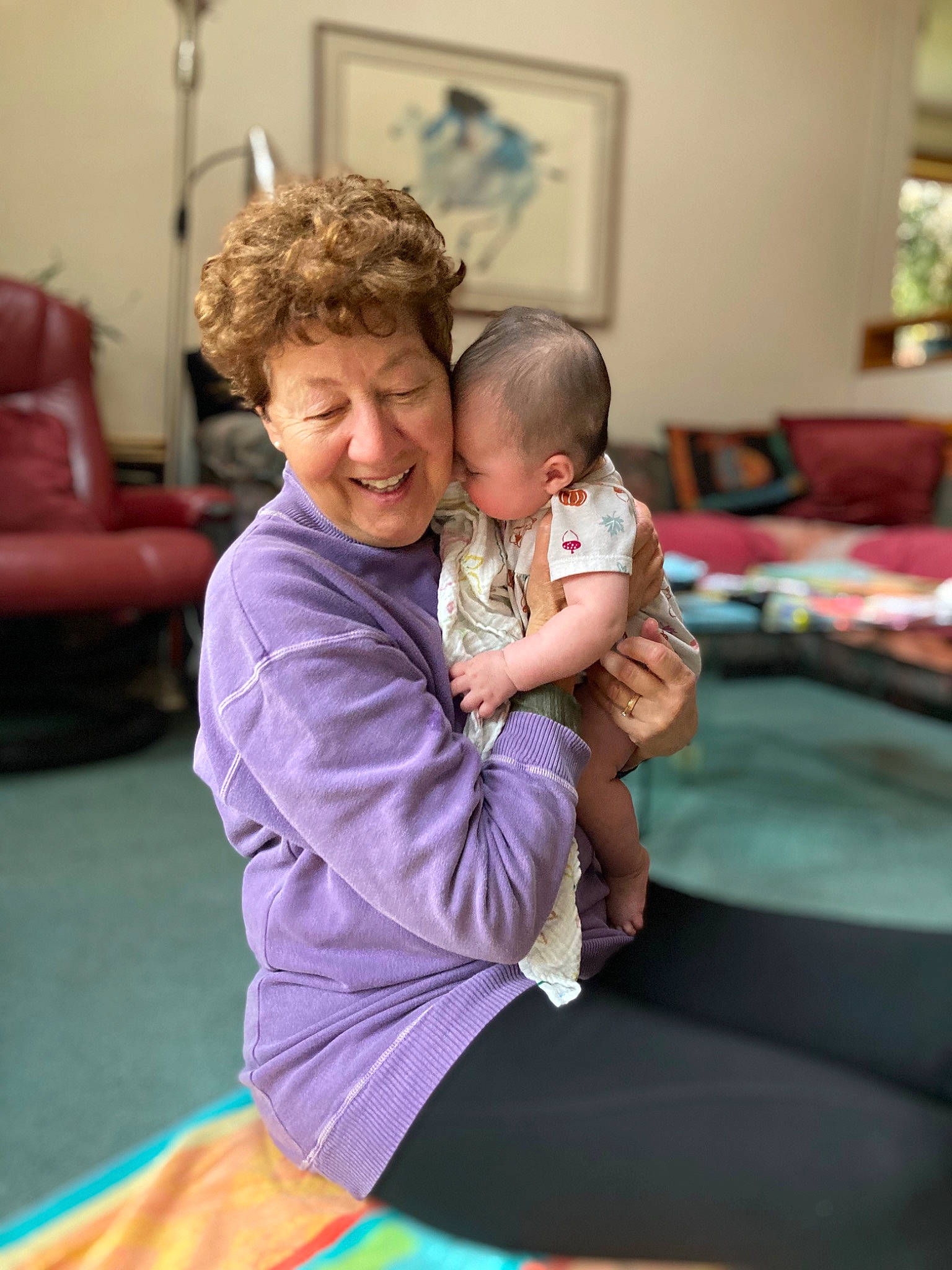 Ayla is registered to the contest to win money with this photo: abdomen, baby, child, comfort, couch, event, fun, happy, joint, joy, knee, lap, leisure, person, picture_frame, room, shorts, sitting, smile, t_shirt