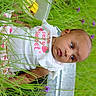 baby, infant, grass, greenery, purple_flower, outdoor, nature, child, curious, cute, white_clothing, portrait, face, head, eyes, lying_down, summer, plants, small_child, baby_girl