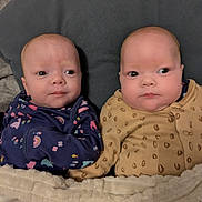 Millie is registered to the contest to win money with this photo: baby, infant, blanket, cushion, clothing, cute, face, person, portrait, newborn, lying_down, sleepwear, indoors, two_babies, baby_girls, cozy, soft, young_children, bedtime, comfort