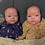 baby, infant, blanket, cushion, clothing, cute, face, person, portrait, newborn, lying_down, sleepwear, indoors, two_babies, baby_girls, cozy, soft, young_children, bedtime, comfort