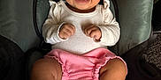 Adamaris is registered to the contest to win money with this photo: baby, baby_accessories, black_hair, car_seat, child, clothing, cute, happy, indoors, infant, knitted_booties, pink_shorts, portrait, raised_fists, seat, seatbelt, smiling, warning_labels, white_top, young_child