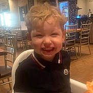 Carter is registered to the contest to win money with this photo: architecture, bodypart, boy, building, child, diningroom, diningtable, face, furniture, head, indoors, interiordesign, male, mouth, person, photography, portrait, restaurant, room, table