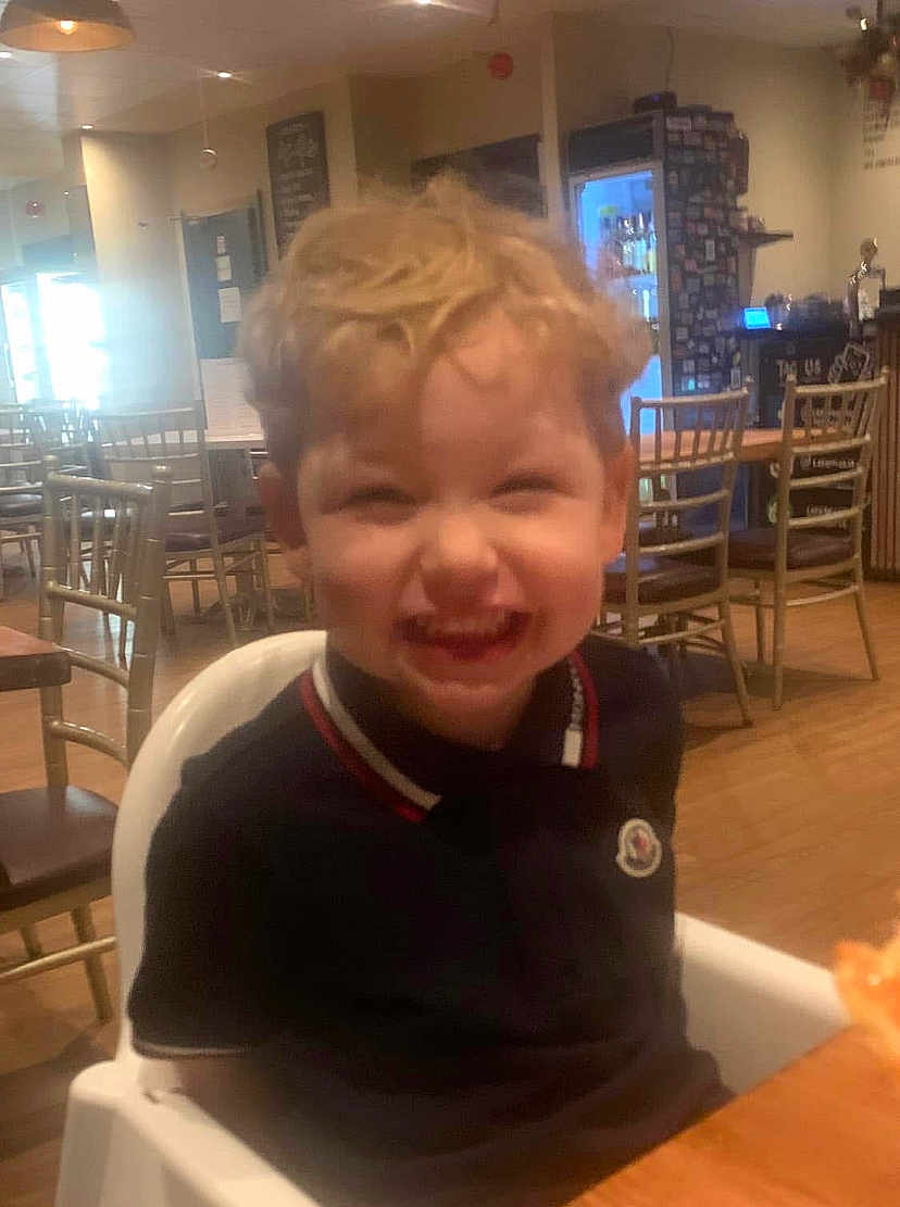 Carter is registered to the contest to win money with this photo: architecture, bodypart, boy, building, child, diningroom, diningtable, face, furniture, head, indoors, interiordesign, male, mouth, person, photography, portrait, restaurant, room, table