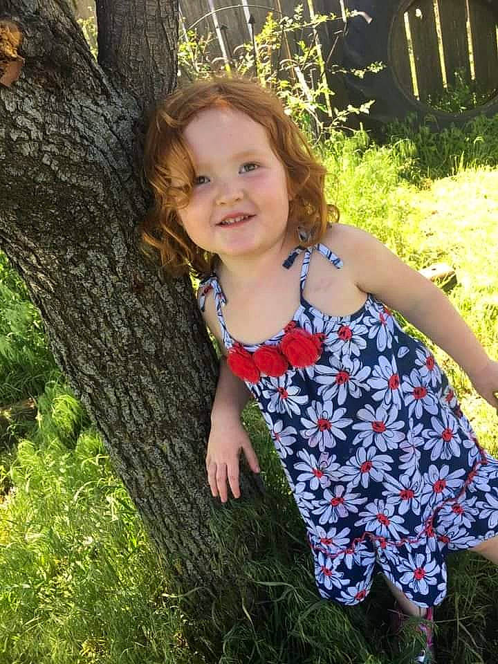 Izabella is registered to the contest to win money with this photo: child, child_model, dress, fawn, grass, happy, joy, pattern, people_in_nature, person, plant, smile, summer, tree