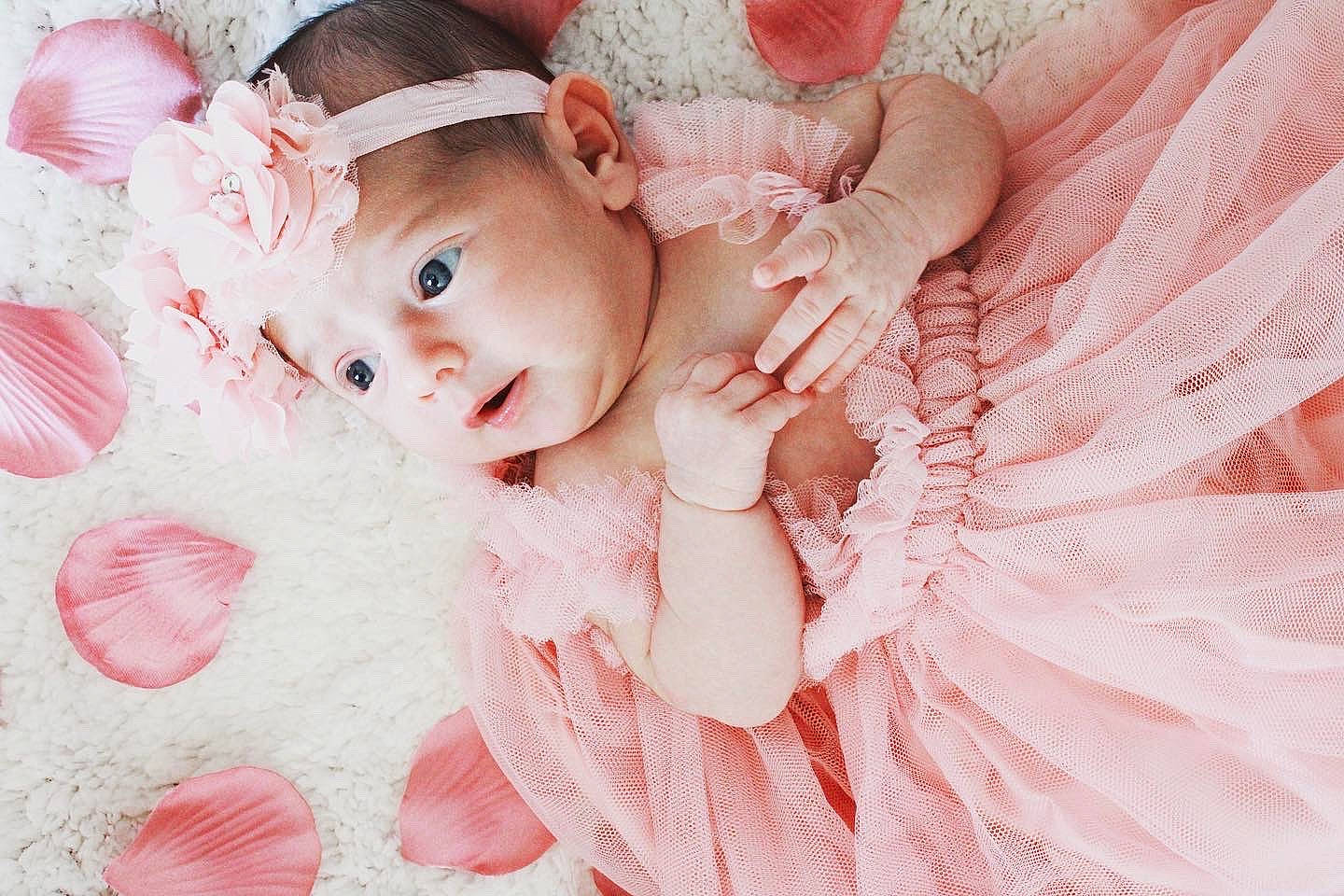 Melody Rose joined the competition — help win amazing prizes! baby, baby_toddler_clothing, child, dress, embellishment, fashion_accessory, flash_photography, grass, hair_accessory, happy, headband, headpiece, headwear, magenta, pattern, peach, person, petal, pink, plant