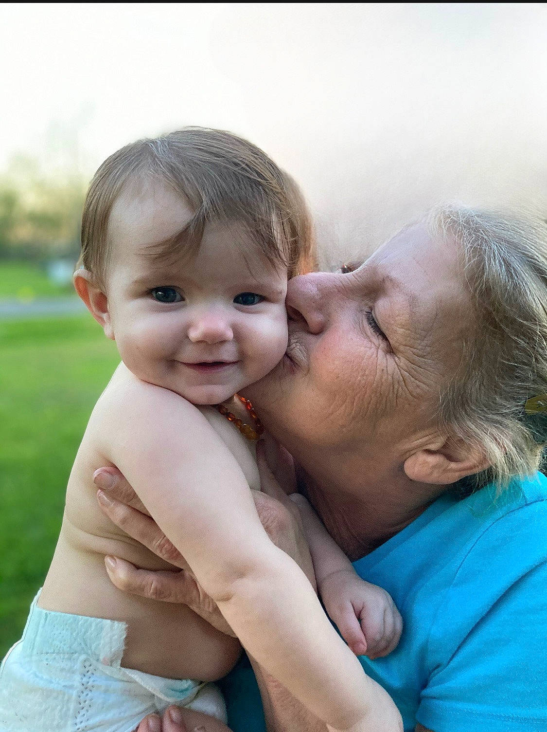 Felicitie is registered to the contest to win money with this photo: baby, cheek, child, face, finger, gesture, grass, hair, happy, iris, joy, kiss, leisure, lip, nose, people_in_nature, person, plant, skin, smile