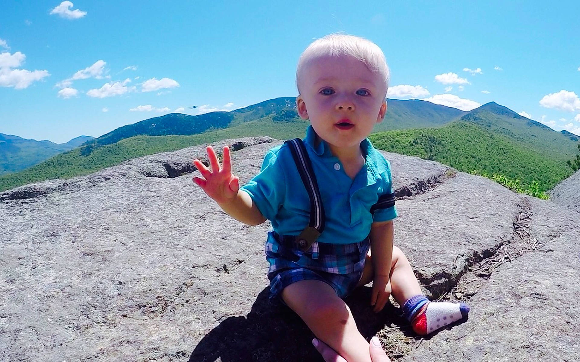 Wyatt is registered to the contest to win money with this photo: adventure, adventurer, child, fell, fun, hill, leisure, mountain, mountain_range, mountainous_landforms, outdoor_recreation, person, personal_protective_equipment, recreation, ridge, rock, sky, summer, tourism, travel