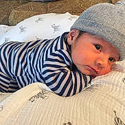 Jeremy joined the competition — help win amazing prizes! baby, infant, striped_clothing, blue_and_white, beanie, hat, blanket, zebra_pattern, couch, indoor, face, eyes, portrait, cute, child, newborn, resting, cozy, soft, home