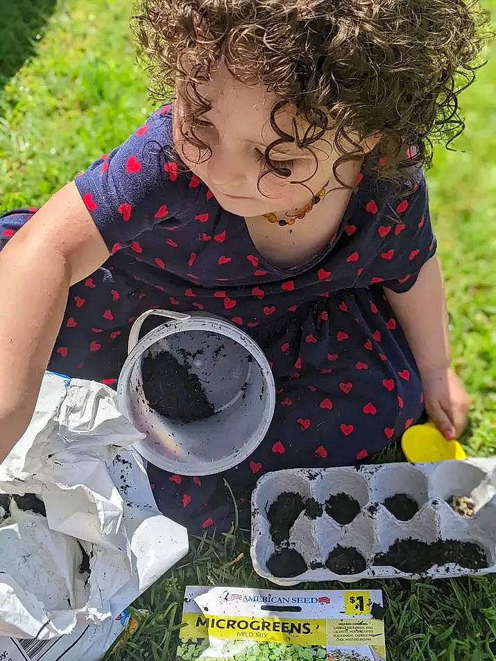 Kayla is registered to the contest to win money with this photo: adaptation, black, child, fun, grass, grass_family, happy, lawn, leisure, pattern, people_in_nature, person, play, recreation, sitting, sleeve, soil, spring, t_shirt, textile