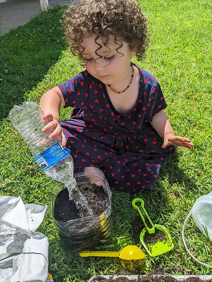 Kayla joined the competition — help win amazing prizes! botany, bottled_water, child, drinking_water, fun, garden, grass, grass_family, groundcover, lawn, leaf, people_in_nature, person, plastic_bag, plastic_bottle, recreation, smile, soil, summer, toddler