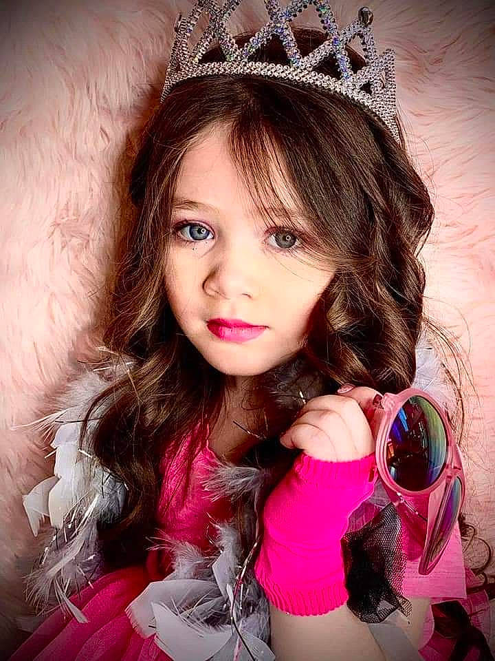 Laylani joined the competition — help win amazing prizes! beauty, bracelet, costume_accessory, crown, eyelash, fashion_accessory, fur, goggles, hair_accessory, headgear, headpiece, lip, long_hair, magenta, mobile_phone, nail, natural_material, person, pink, sunglasses