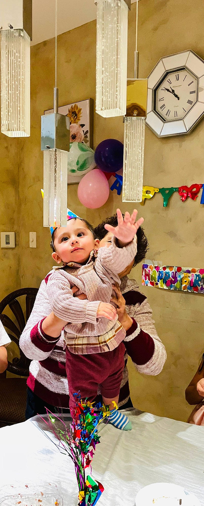 Ali is registered to the contest to win money with this photo: baby, balloon, child, entertainment, event, fun, gesture, happy, headwear, leisure, party, party_supply, performing_arts, person, play, purple, recreation, room, sharing, snapshot