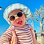 baby, child, cute, daylight, fashion, hand, happy, hat, nature, outdoor, person, playful, sky, smile, striped_clothing, summer, sunglasses, sunny, tongue_out, tree