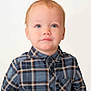 toddler, child, portrait, blue_eyes, red_hair, plaid_shirt, casual_clothing, buttoned_shirt, young_child, innocence, studio_photo, white_background, curious_expression, face, person, head_and_shoulders, indoor, cute, smile, fashion
