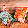Kaysan participe au concours pour gagner de l'argent avec cette photo : toddler, child, painting, palette, paintbrush, artwork, easel, wooden_floor, wooden_background, green_leaves, smiling, barefoot, sitting, hoodie, pants, indoor, colorful, creative, portrait, happy