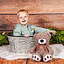 Kaysan participe au concours pour gagner de l'argent avec cette photo : toddler, child, bucket, teddy_bear, plush_toy, smiling, wooden_floor, wooden_wall, green_leaves, fluffy_rug, indoor, portrait, cute, happy, baby_clothes, light_blue_jacket, decor, playful, sitting, photography