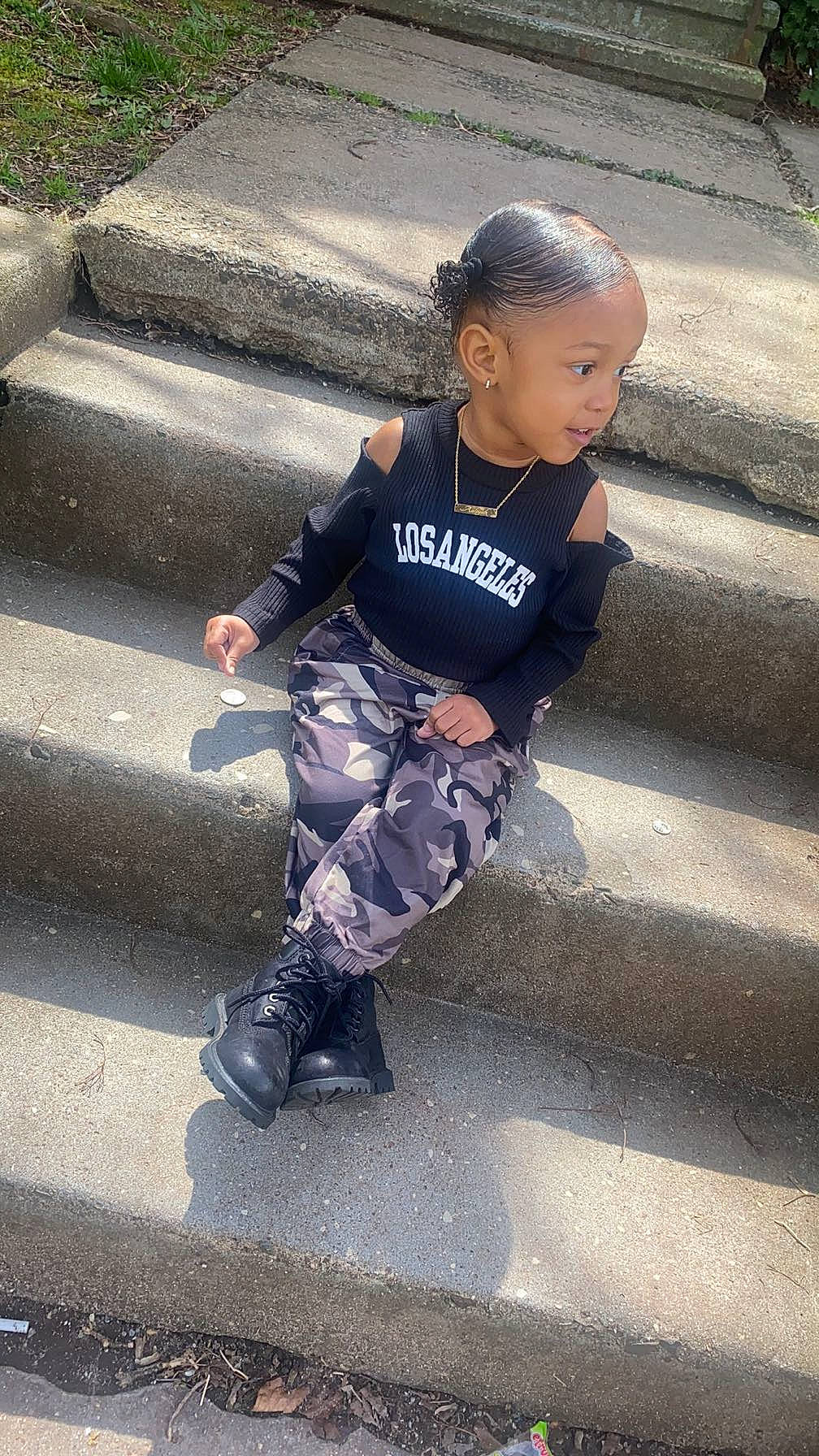 Aaliyah is registered to the contest to win money with this photo: accessories, child, clothing, face, female, footwear, girl, hair, head, jeans, jewelry, pants, path, person, photography, portrait, shoe, sitting, sleeve, walkway