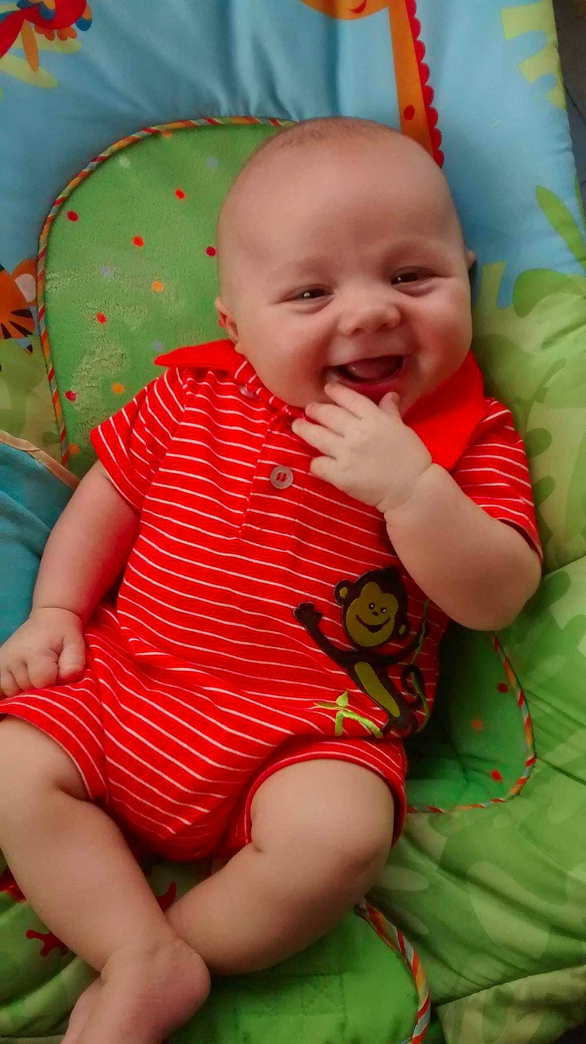 Aveon is registered to the contest to win money with this photo: baby_toddler_clothing, cheek, eye, face, facial_expression, finger, grass, green, head, human_body, joy, mammal, mouth, nose, organ, person, pink, product, skin, sleeve