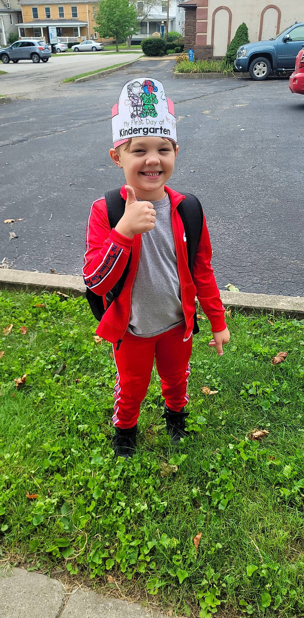 Aveon is registered to the contest to win money with this photo: baby_toddler_clothing, cap, eye, face, glove, grass, groundcover, happy, head, headgear, headwear, jacket, joy, leaf, leisure, people_in_nature, person, personal_protective_equipment, plant, red