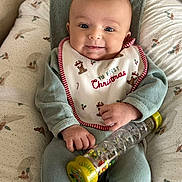 Alicia participe au concours pour gagner de l'argent avec cette photo : baby, infant, smiling, bib, christmas, toy, cushion, clothing, child, face, hand, sitting, pattern, comfort, indoor, cute, happy, portrait, seasonal, holiday