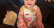 Layken joined the competition — help win amazing prizes! 8_months, baby, blanket, child, clothing, couch, cute, decorative_sign, fruit_pattern, happy, headwear, indoors, infant, milestone_sign, person, pink_headband, portrait, sitting, smiling, young_child