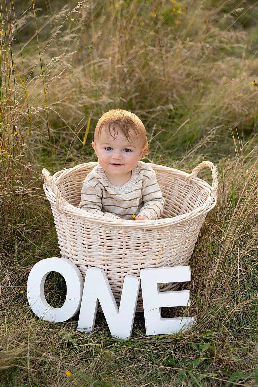 Zaden joined the competition — help win amazing prizes! baby, basket, grass, outdoor, child, smiling, sweater, nature, field, letters, one, celebration, cute, portrait, infant, first_birthday, happy, young, sitting, daylight