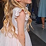 Lily Rose is registered to the contest to win money with this photo: child, girl, smiling, laughing, dress, white_dress, curly_hair, long_hair, party, celebration, indoor, people, formal_clothing, happy, cute, portrait, event, floor, woman, person