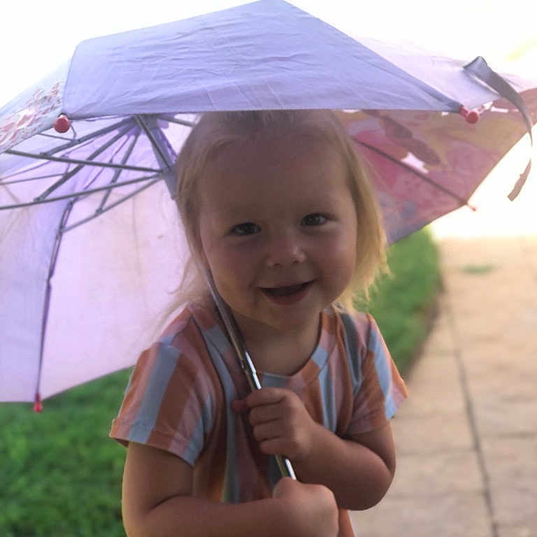 Adeline joined the competition — help win amazing prizes! architecture, bodypart, building, canopy, child, clothing, face, female, finger, girl, grass, hand, head, outdoors, person, photography, plant, portrait, shelter, umbrella