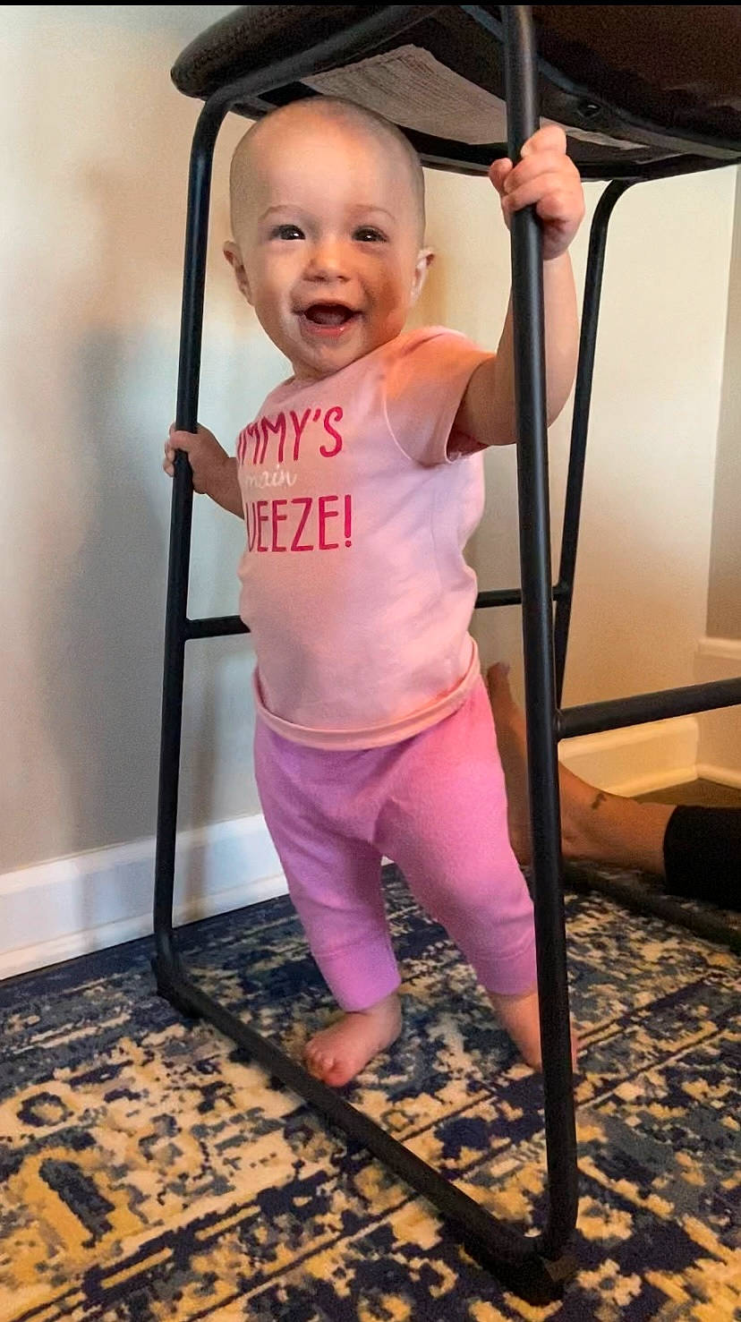 Magnolia is registered to the contest to win money with this photo: baby, baby_toddler_clothing, balance, child, cleanliness, eye, face, floor, flooring, happy, head, knee, magenta, person, pink, purple, sleeve, smile, t_shirt, toddler