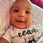 Josiah joined the competition — help win amazing prizes! baby, smiling, face, dimples, eyes, shirt, text, blanket, bed, indoor, child, infant, cute, happy, portrait, closeup, light, window, curtains, skin