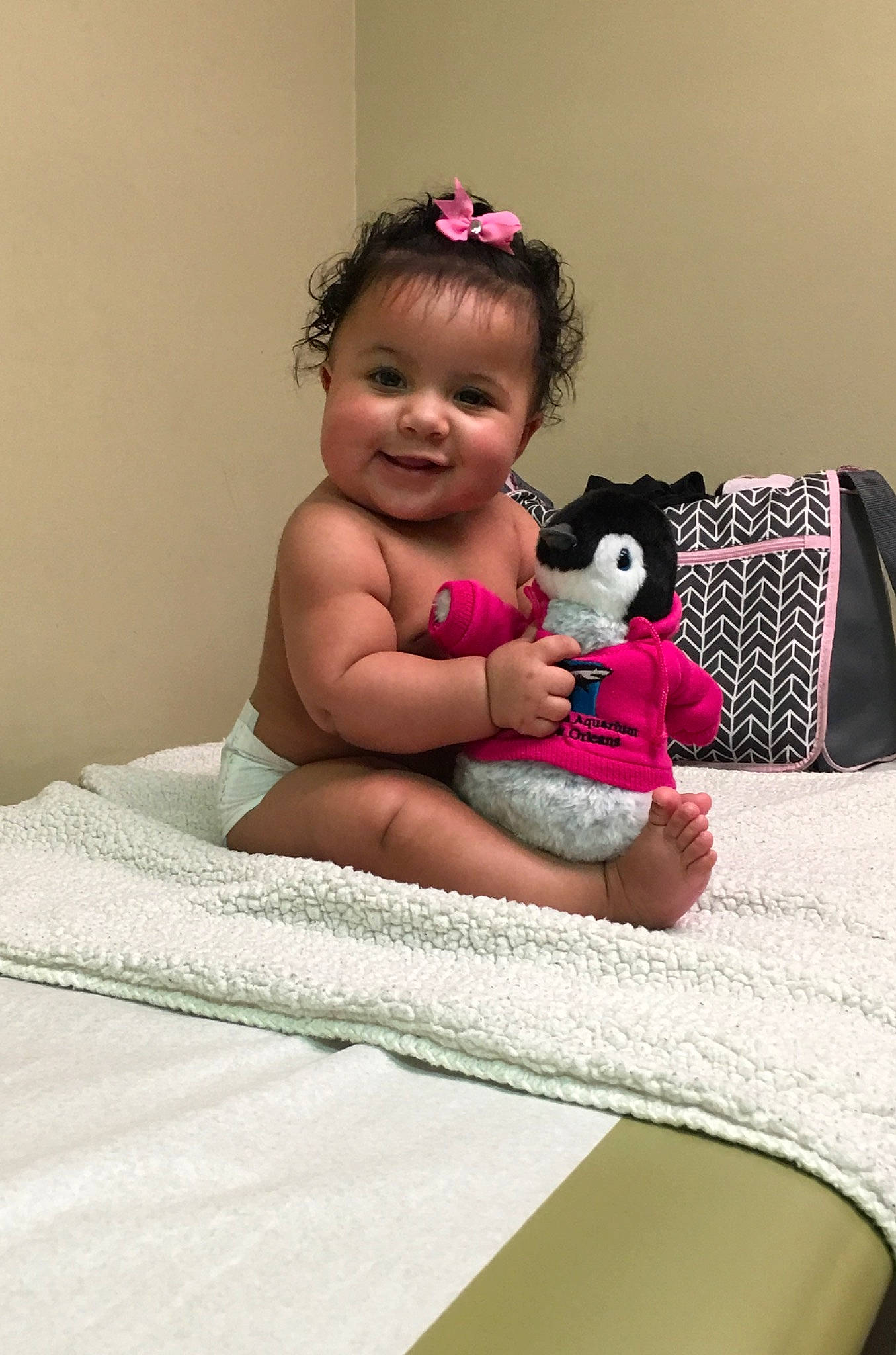 Hermione is registered to the contest to win money with this photo: arm, baby, cheek, child, daughter, ear, happy, head, joy, person, pink, room, sitting, skin, smile, teddy_bear, toddler