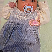 Anna joined the competition — help win amazing prizes! baby, infant, pacifier, headband, dress, lace, pink_accessories, hand, face, eyes, lying_down, clothing, footwear, bed, quilted_surface, cute, portrait, child, indoors, newborn