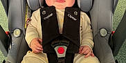 Finlay is registered to the contest to win money with this photo: baby, car_seat, child, comfort, cute, fabric, face, feet, floor, hands, head_support, indoor, infant, onesie, padding, safety, seatbelt, smiling, strap, toy