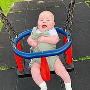 Finlay joined the competition — help win amazing prizes! baby, child, clothing, cute, fun, grass, greenery, happy, infant, joyful, metal_chains, outdoor, person, playground, rubber_mat, seat, smiling, summer, swing, white_socks