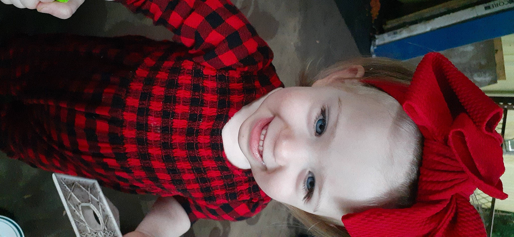 Delaney is registered to the contest to win money with this photo: cheek, collar, comfort, design, eyelash, happy, jaw, joy, lip, mouth, nose, organ, pattern, person, plaid, red, sleeve, smile, tartan, textile