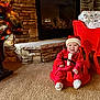 Nickeil joined the competition — help win amazing prizes! baby, child, santa_claus_outfit, red_clothing, smiling, christmas, holiday, presents, gift_wrap, fireplace, stone_wall, carpet, indoor, decor, pine_tree, lights, festive, seat, sleigh, happy