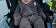 Nickeil joined the competition — help win amazing prizes! baby, child, stroller, onesie, bear_ears, toy, outdoor, smile, happy, infant, clothing, blanket, person, cute, seat, plush, hood, face, grass, sidewalk