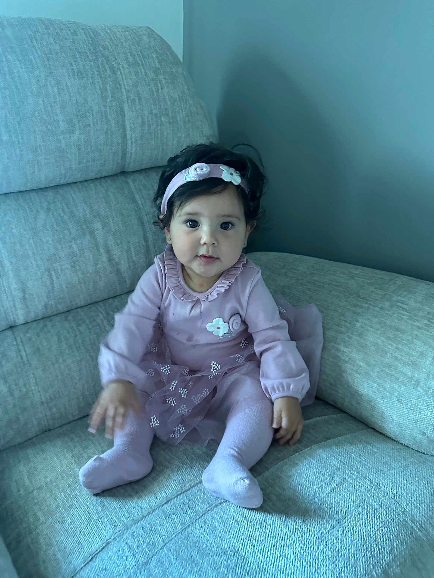 Kamila joined the competition — help win amazing prizes! baby, child, girl, purple_clothing, headband, sitting, couch, indoor, cute, smiling, portrait, toddler, long_sleeves, tights, fabric, furniture, person, young_child, home, cozy