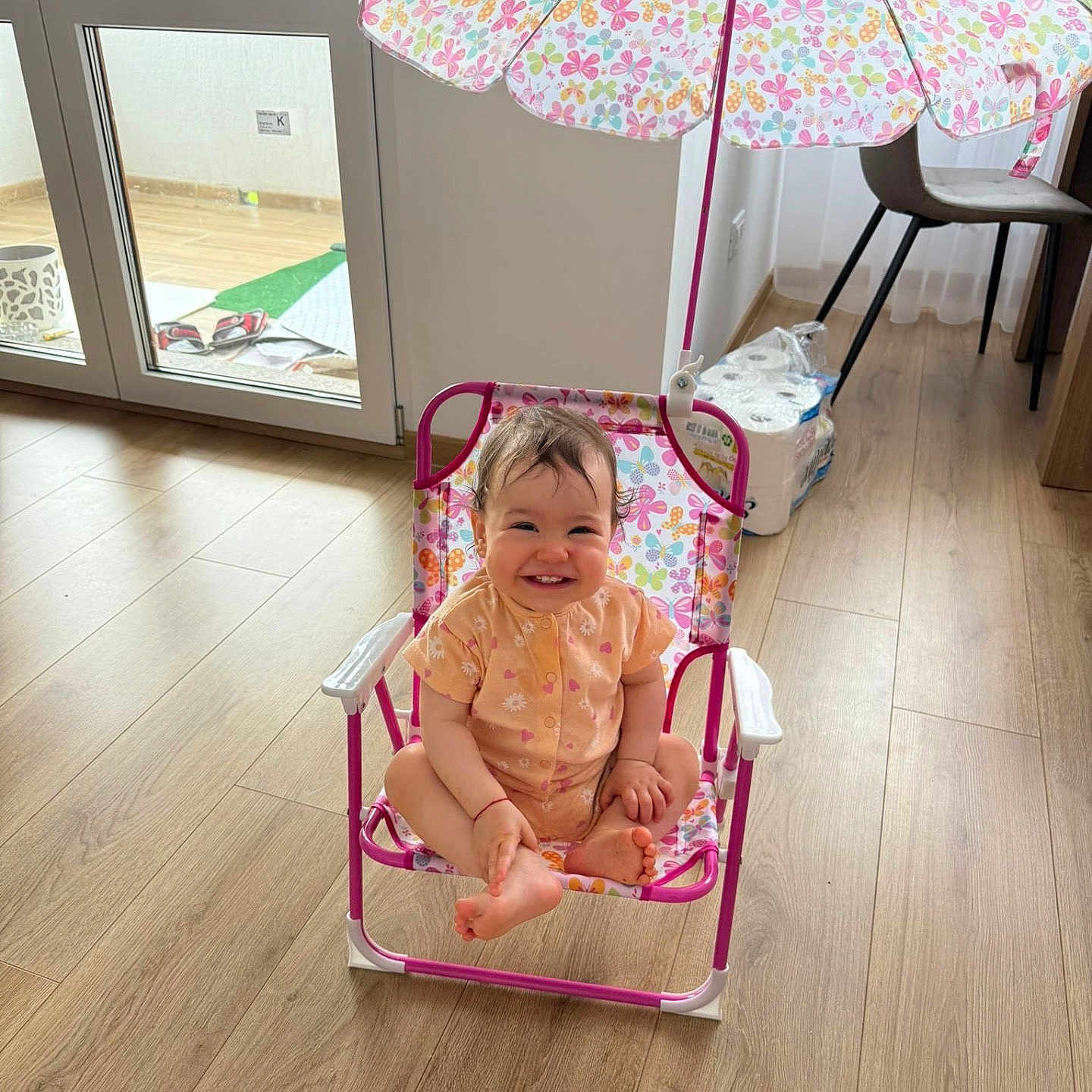 Rachele joined the competition — help win amazing prizes! baby, butterfly, chair, child, colorful, cute, door, flooring, footwear, furniture, happy, indoor, natural_light, pattern, person, room, smiling, umbrella, window, wooden_floor