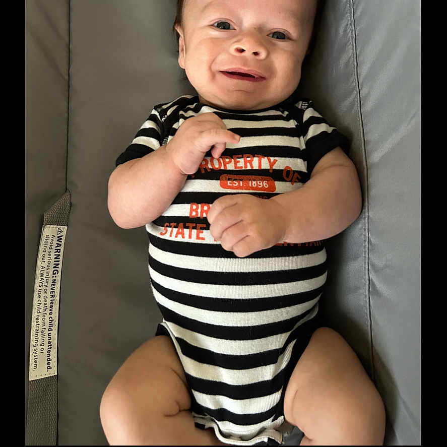 Mateo joined the competition — help win amazing prizes! baby, bodypart, clothing, couch, cushion, face, finger, furniture, hand, happy, head, homedecor, laughing, mouth, newborn, person, photography, portrait, smile, t_shirt