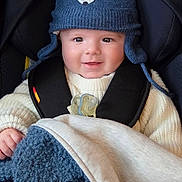 Marius a rejoint le concours — aidez-le/la à gagner de superbes lots ! baby, child, smiling, hat, knit_hat, bear_design, car_seat, blanket, blue_blanket, cream_blanket, clothing, cute, indoors, person, infant, warm_clothing, happy, face, portrait, seatbelt
