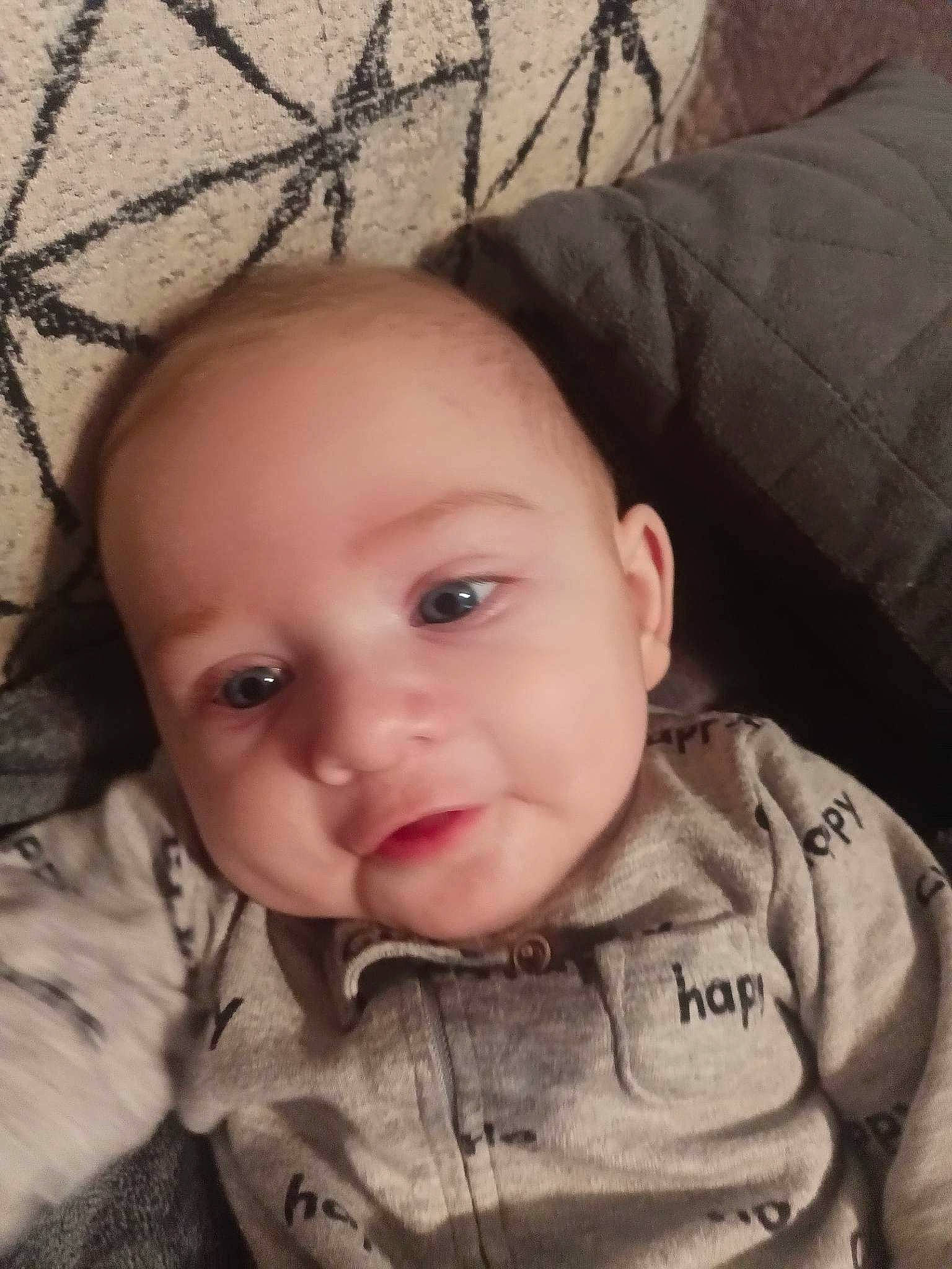 Chase is registered to the contest to win money with this photo: baby, baby_toddler_clothing, cheek, chin, comfort, eyebrow, eyelash, forehead, human, iris, lip, mesh, mouth, nose, outerwear, person, skin, sleeve, textile, toddler