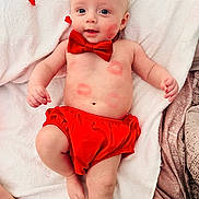 Walker joined the competition — help win amazing prizes! baby, infant, bow_tie, red_bow_tie, red_clothing, lipstick_marks, kisses, blanket, white_blanket, lying_down, blue_eyes, smile, cute, soft_texture, skin, belly, hand, foot, portrait, hearts