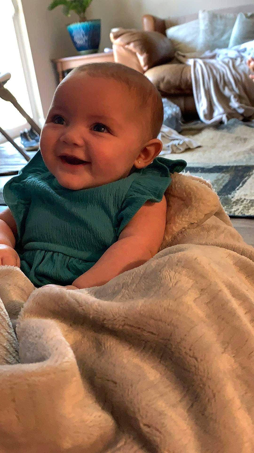 Oaklyn joined the competition — help win amazing prizes! baby, baby_laughing, baby_toddler_clothing, cheek, child, chin, comfort, eye, face, fun, happy, linens, nose, person, sand, sitting, skin, smile, thumb, toddler