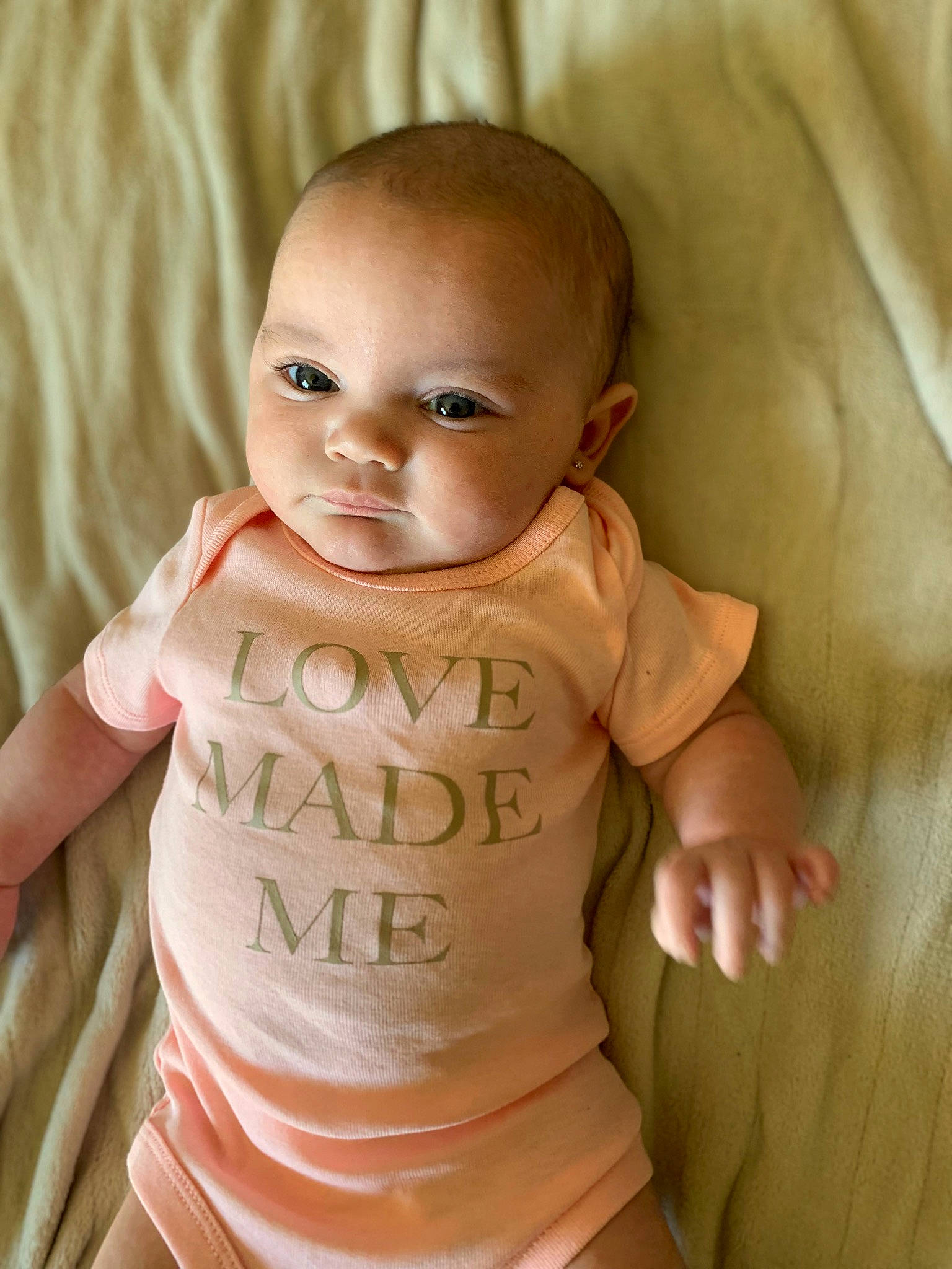 Oaklyn is registered to the contest to win money with this photo: abdomen, baby, baby_toddler_clothing, chair, cheek, chest, eye, eyebrow, gesture, happy, head, human_body, iris, lip, nose, person, skin, sleeve, stomach, trunk